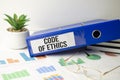 code of ethics Concept. Words on notebook and blue folder Royalty Free Stock Photo