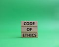 Code of ethics symbol. Concept words Code of ethics on wooden blocks. Beautiful green background. Business and Code of ethics Royalty Free Stock Photo