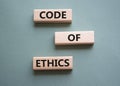 Code of ethics symbol. Concept words Code of ethics on wooden blocks. Beautiful grey green background. Business and Code of ethics Royalty Free Stock Photo