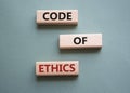 Code of ethics symbol. Concept words Code of ethics on wooden blocks. Beautiful grey green background. Business and Code of ethics Royalty Free Stock Photo