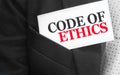 Code of ethics words on card in Businessman upper suit pocket. Business ethic concept