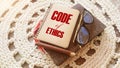 Code Of Ethics words on notebook, pen, glasses, crochet cloth. Business concept. Moral Rules Ethical Integrity Honesty Good