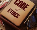 Code Of Ethics words on notebook, pen, glasses, crochet cloth. Business concept. Moral Rules Ethical Integrity Honesty