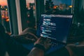The code on the laptop screen at night. Software development. Developer is programming a code script late at night Royalty Free Stock Photo