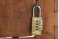 Code padlock on wooden small door Royalty Free Stock Photo