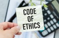 CODE OF PRACTICE text on paper with calculator, notepad, coffee ,pen with graph Royalty Free Stock Photo