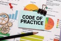 CODE OF PRACTICE text on the paper sheet with chart,color paper and calculator Royalty Free Stock Photo