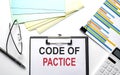 CODE OF PRACTICE text on paper sheet with chart,color paper and calculator Royalty Free Stock Photo