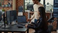 Coder holding laptop with coding interface entering software development agency office sitting down Royalty Free Stock Photo