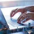 Coder\'s City: Hands Typing on Laptop with Code Overlay and Urban Skyline Royalty Free Stock Photo