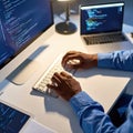 A coder types code on a keyboard in a modern office setting at his desk. Royalty Free Stock Photo