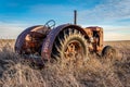 Coderre, SK- April 9, 2020: Sunset over a vintage Case tractor on the prairies in Saskatchewan