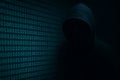 A coding hacker in the background with binary code Royalty Free Stock Photo