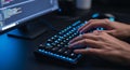 Coding Hands Typing on Lit Keyboard with Blue Screen Displaying Source Code on a Dark Desk Creating a Cybersecurity Royalty Free Stock Photo