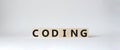 Coding symbol. Concept word Coding on wooden cubes. Beautiful white background. Business and Coding concept. Copy space Royalty Free Stock Photo