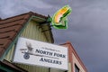 Neon fish sign for Tim Wades North Fork Anglers sporting goods store in the downtown area