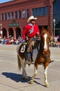 Cody, Wyoming, USA - Cowboy with bright red shirt riding on the Independence Day Parade Royalty Free Stock Photo