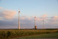 Hand in hand wind mill farm with agricultural fields Royalty Free Stock Photo