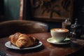 cofee break ritual with a latte and croissant in the old-fashioned cafe