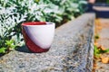 Cofee break,tea time.Red cup on stone in street Royalty Free Stock Photo