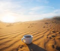 Cofee cup on the sand at the sunset Royalty Free Stock Photo
