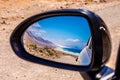 Cofete beach in a car mirror