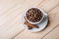 Coffe beans in white cup with cinamone. Royalty Free Stock Photo