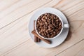 Coffe beans in white cup with cinamone. Royalty Free Stock Photo
