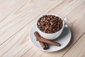 Coffe beans in white cup with cinamone. Royalty Free Stock Photo