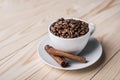 Coffe beans in white cup with cinamone. Royalty Free Stock Photo