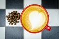 Coffe Cup with Beans on Checkedboard Royalty Free Stock Photo