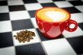 Coffe Cup with Beans on Checkedboard Royalty Free Stock Photo