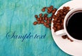 Coffe in cup with coffee beans around it Royalty Free Stock Photo