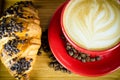 Coffe Cup and Croissant with Beans on Plate Royalty Free Stock Photo