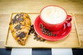 Coffe Cup and Croissant with Beans on Plate Royalty Free Stock Photo