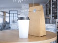 Coffe cup and paper bag on table. 3d rendering Royalty Free Stock Photo