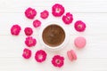 Coffee cup, roses and pink macaroon on white wooden background Royalty Free Stock Photo