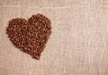 Coffe heart on sacking background Royalty Free Stock Photo