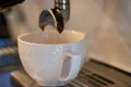 coffe machine pouring espresso in white cup in cafe Royalty Free Stock Photo