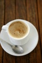 Coffe with milk white cup over teak wooden Royalty Free Stock Photo