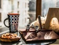 Coffe table with mug, book and lorgnette.