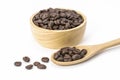 Closeup roasted coffee beans in wooden bowl on white background. Royalty Free Stock Photo