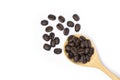 Closeup roasted coffee bean in wooden spoon isolated on white background. Royalty Free Stock Photo