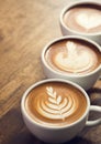 Coffee cups decorated with milk froth.