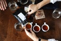 Coffee accessories on a dark wooden table. Spills coffee from a serving jug