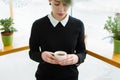 Coffee addict young girl holding cup hot drink