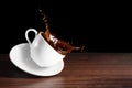 Coffee advertising design. Coffee beans, cup of tilted coffee with a splash effect