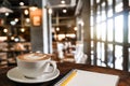 Coffee aroma in cup breakfast morning drink on wooden table in cafe shop with note pad and newspaper restaurant Royalty Free Stock Photo