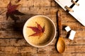 Coffee with autumn leaf on a table Royalty Free Stock Photo