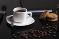 Coffee background with beans and white cup. Dark atmosphere and copy space. Oatmeal cookies and notebook Royalty Free Stock Photo